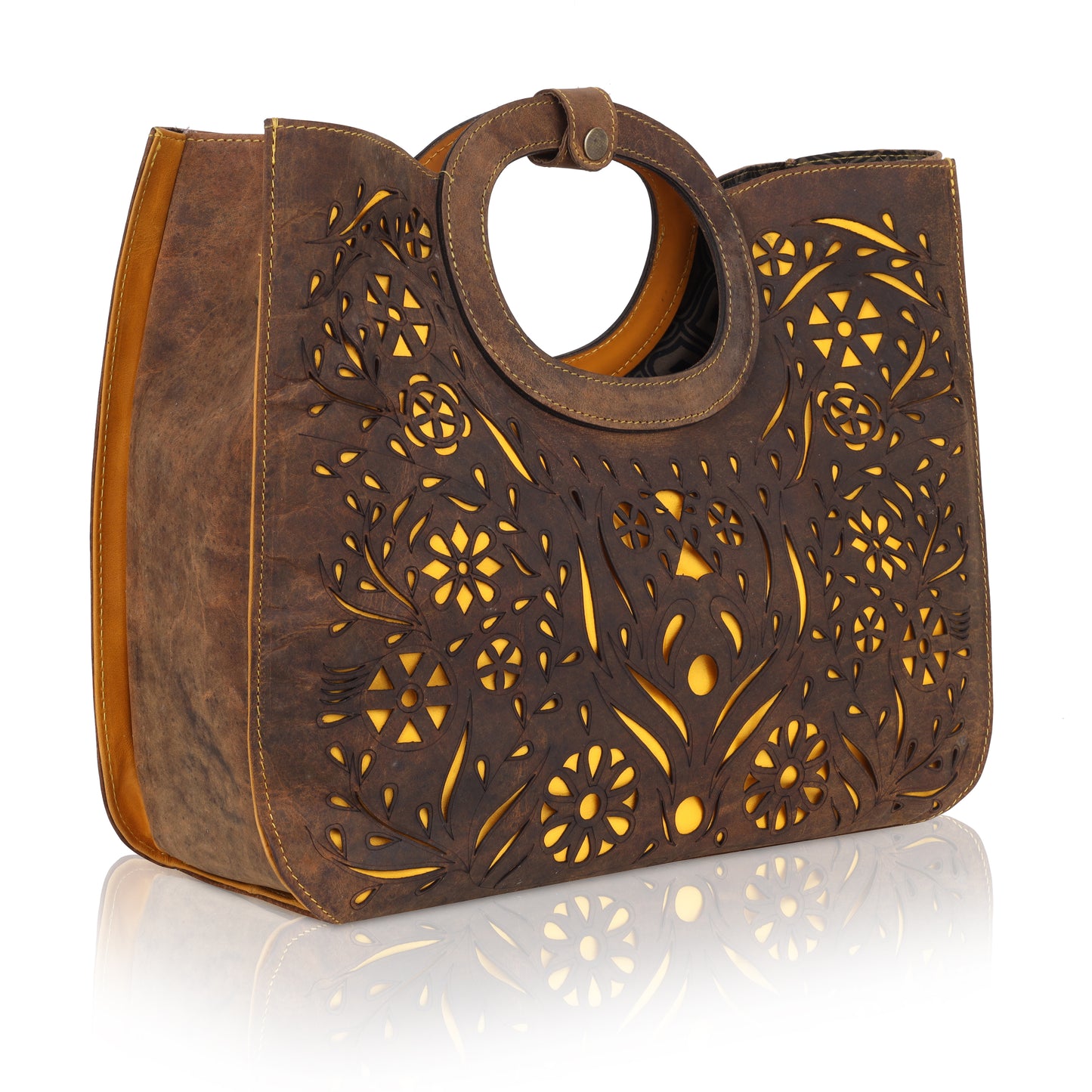 This unique tote bag features an intricate laser-cut floral pattern on rich brown leather, with a golden inner lining that shines through the cutwork for a striking effect